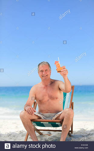 senior-man-drinking-a-cocktail-on-the-beach-X1A1CE