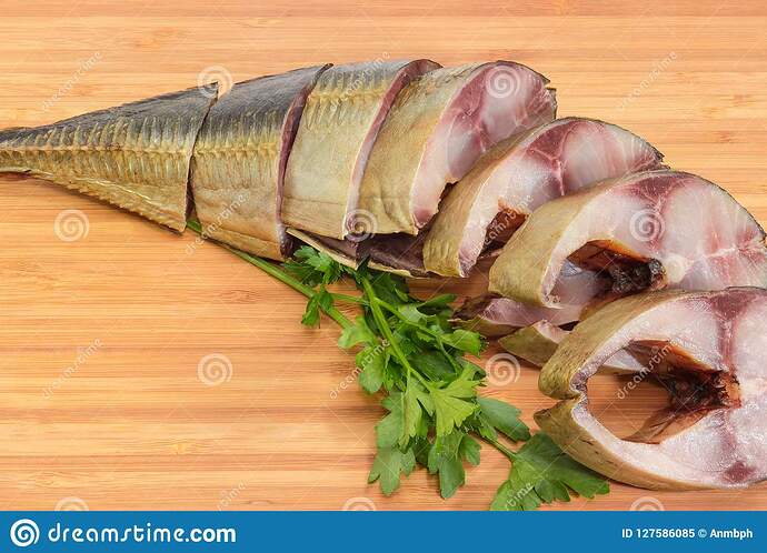 sliced-smoked-atlantic-horse-mackerel-cutting-board-close-up-sliced-smoked-gutted-atlantic-horse-mackerel-twigs-parsley-127586085