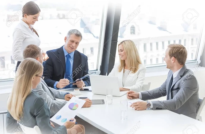 121311810-mixed-group-of-white-collar-workers-at-business-meeting-discuss-documents-business-man-reading-contr