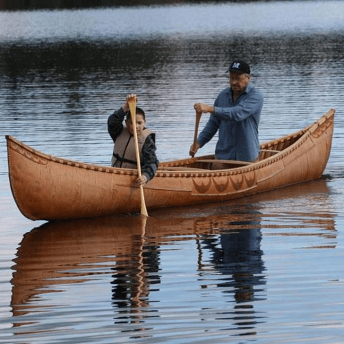 man in canoe with son