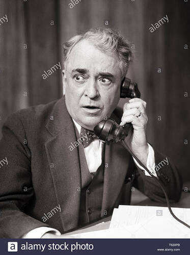 1930s-business-man-listening-on-telephone-with-alarmed-shocked-worried-facial-expression-t3549-har001-hars-nostalgia-old-fashi...lephones-attorney-focused-intense-managers-salesmen-black-and-white-caucasian-ethnicity-har001-intent-old-fashioned-T630PB