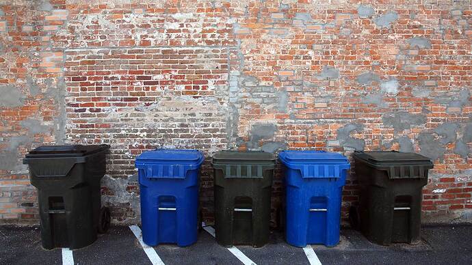 Trash-Cans-Against-a-Brick-Wall