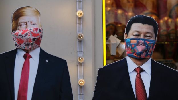 Cardboard cutouts of US President Donald Trump and Chinese President Xi Jinping, with protective masks widely used as a preventive measure against coronavirus disease (Covid-19), near a gift shop in Moscow, Russia