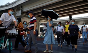 People wear protective masks as they head to work during morning rush hour in the Central Business District following an outbreak of coronavirus in Beijing, China, 15 June 2020.