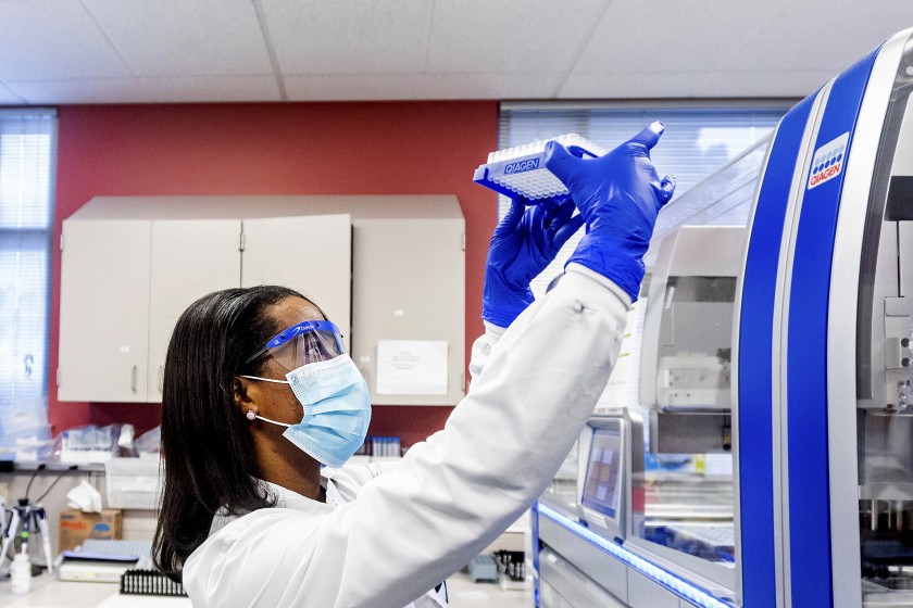 A clinical lab scientist processes upper respiratory samples from patients suspected of having COVID-19.